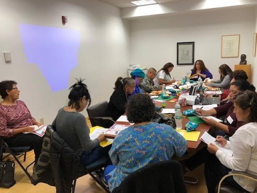 A COSP group of educators sitting around a table