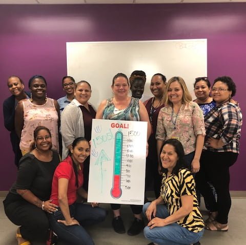 A group of caregivers standing and smiling