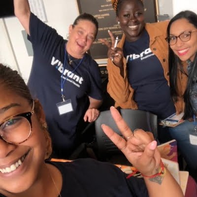 Four multilingual registered COSP facilitators smiling for the camera